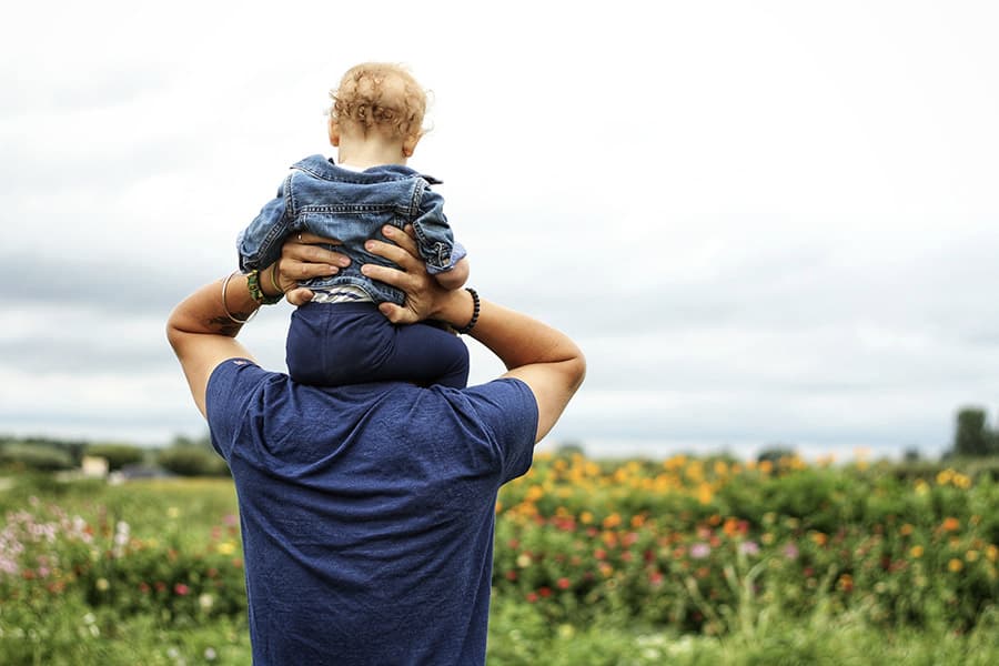 father holding his son on shoulders