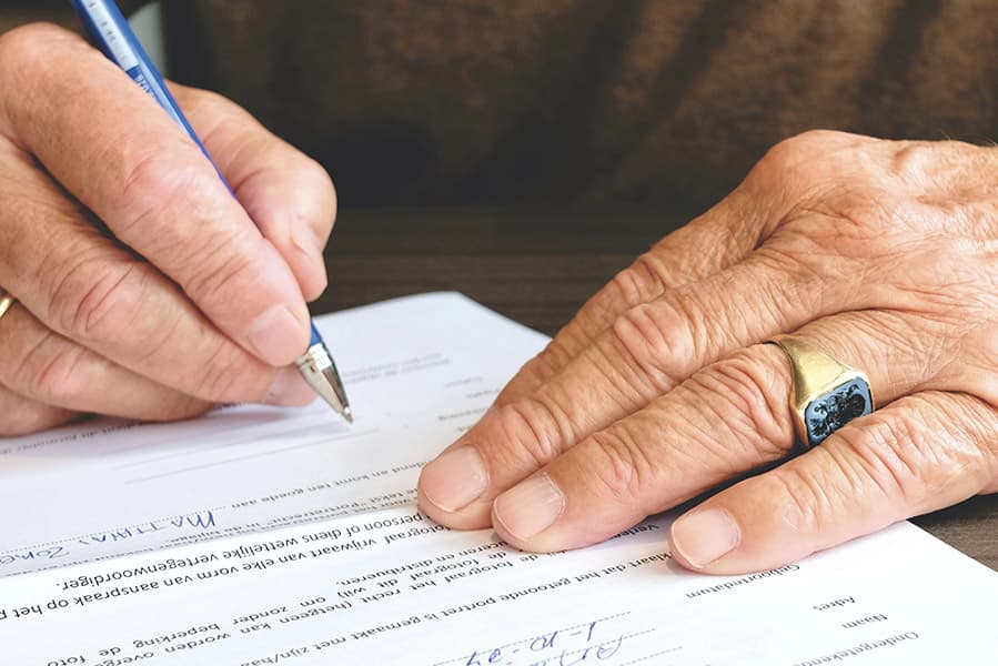 man signing papers