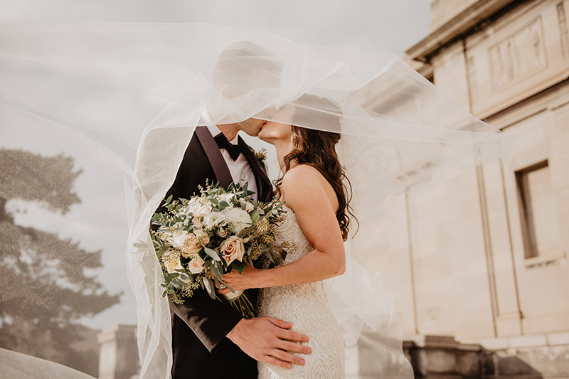 couple kissing on wedding day