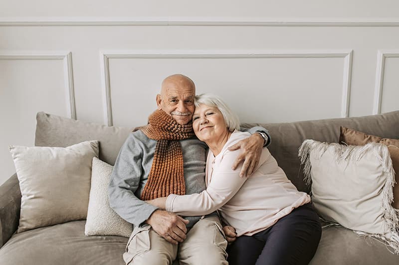 elderly couple hugging