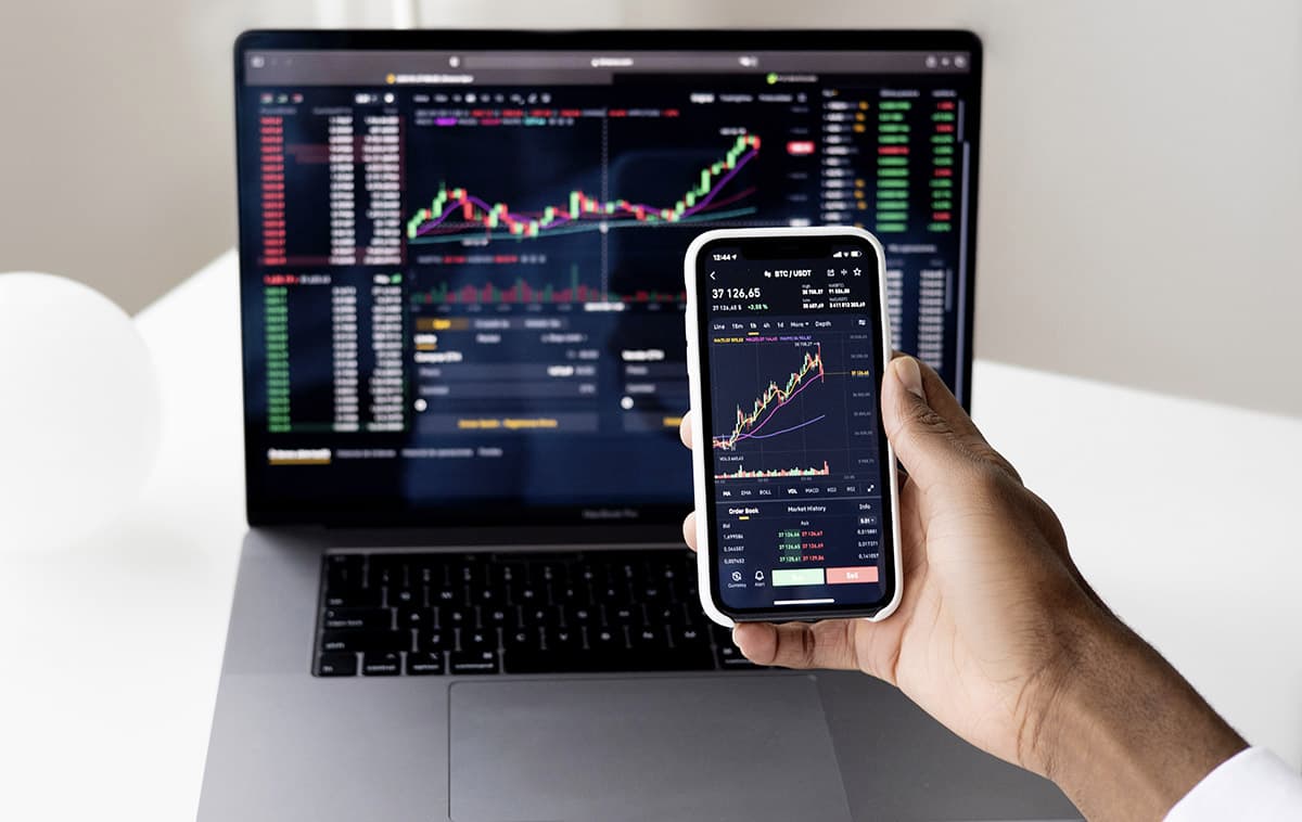 stock charts on computer and phone